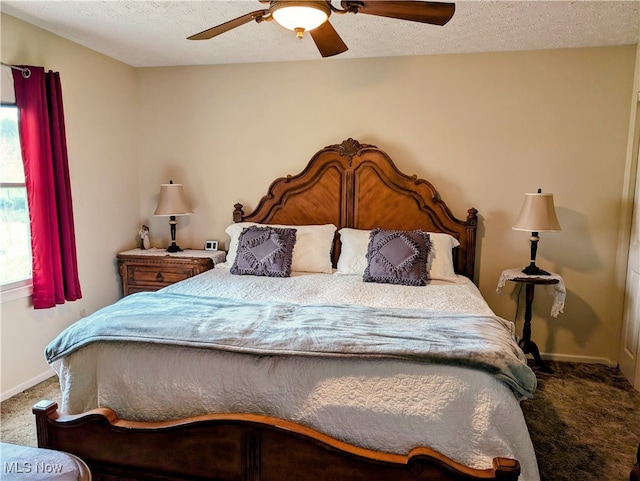 bedroom featuring a textured ceiling, ceiling fan, and carpet floors