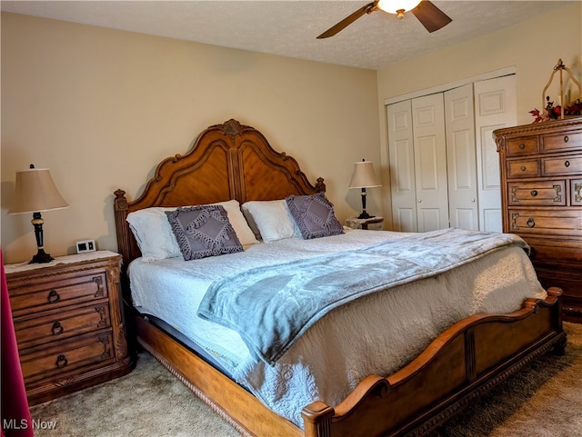 carpeted bedroom with a closet, a textured ceiling, and ceiling fan