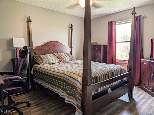 bedroom featuring ceiling fan, a textured ceiling, and light wood-type flooring