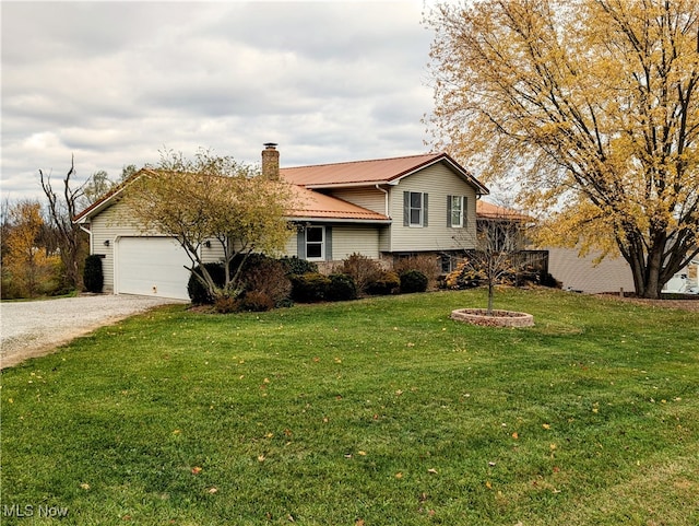 split level home with a garage and a front lawn