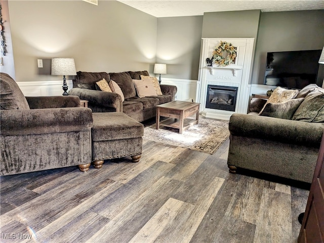 living room with wood-type flooring and a textured ceiling