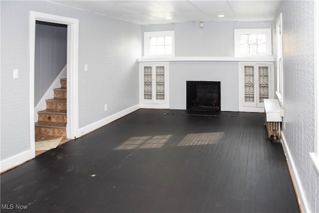 unfurnished living room with dark wood-type flooring