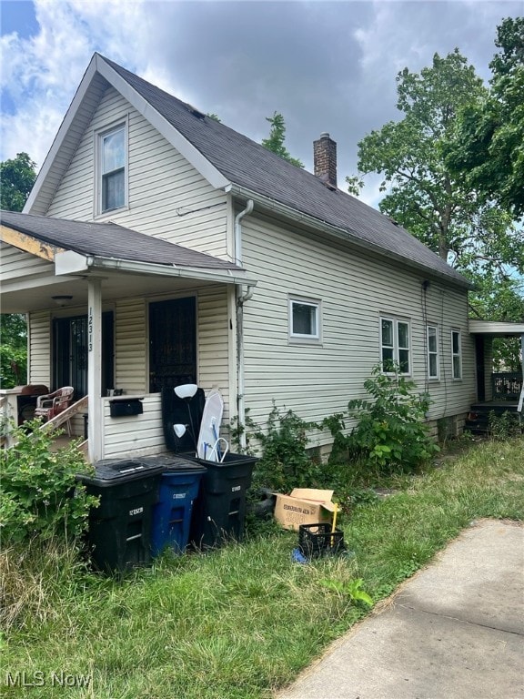 view of side of property with a porch