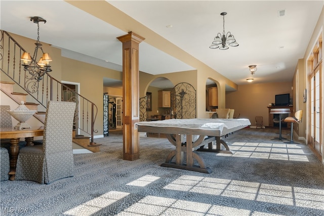 recreation room featuring visible vents, arched walkways, carpet flooring, decorative columns, and a chandelier