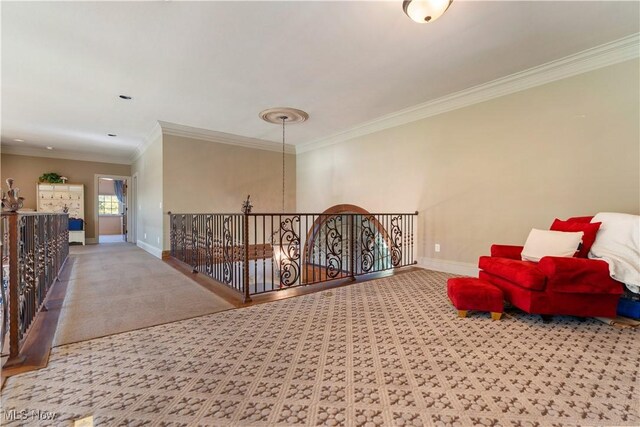 living area with crown molding, carpet, and baseboards