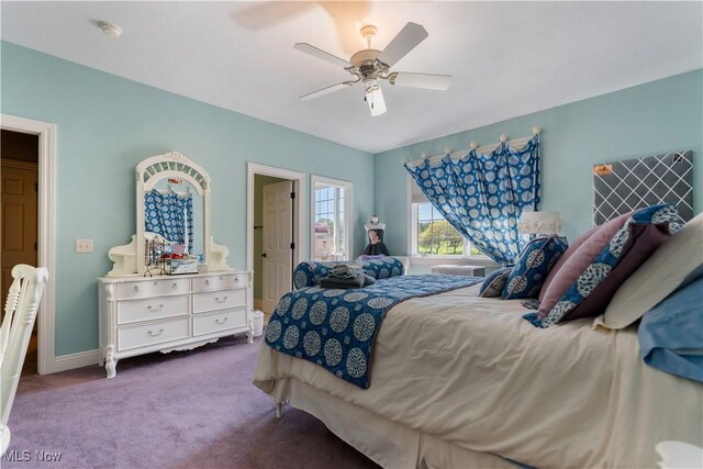 carpeted bedroom featuring baseboards and ceiling fan