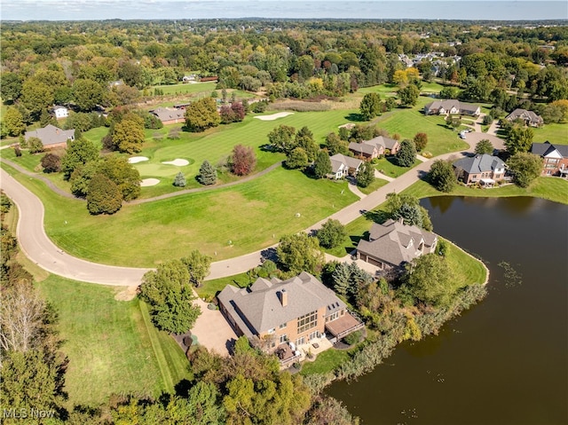 birds eye view of property with a wooded view and a water view