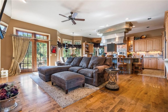 living area with light wood finished floors, recessed lighting, and a ceiling fan