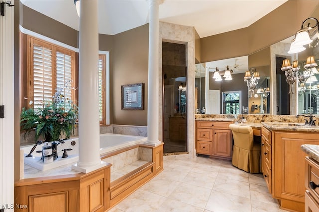 bathroom with decorative columns, tile patterned floors, vanity, a chandelier, and shower with separate bathtub