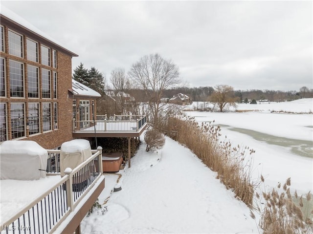 snowy yard featuring a hot tub