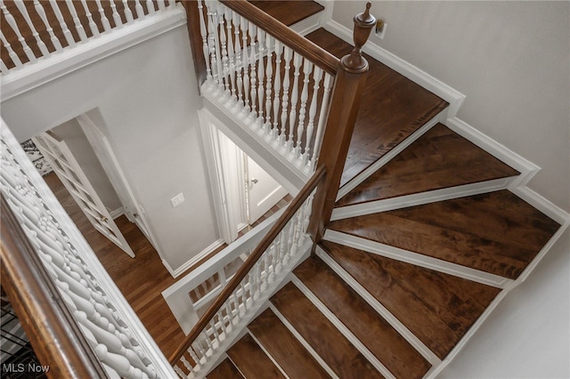 stairway featuring wood-type flooring