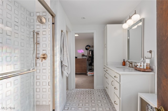 bathroom with vanity and a shower