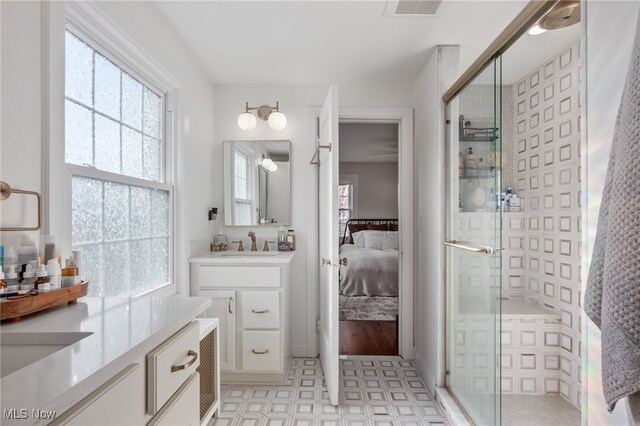 bathroom featuring vanity and a shower with shower door