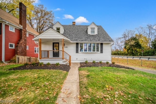 view of front of home with a front yard and covered porch