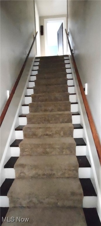 staircase featuring hardwood / wood-style flooring