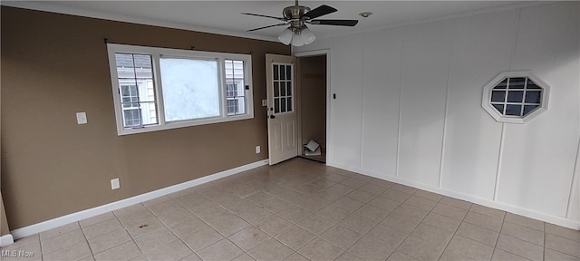 tiled spare room featuring ceiling fan and crown molding