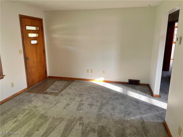 foyer featuring dark carpet