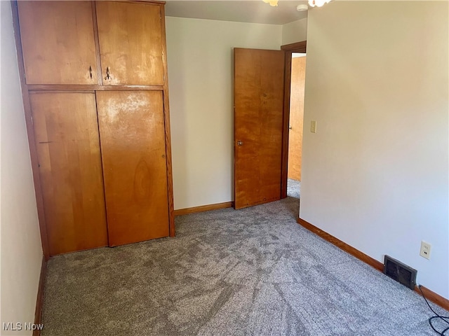 unfurnished bedroom with a closet and carpet flooring