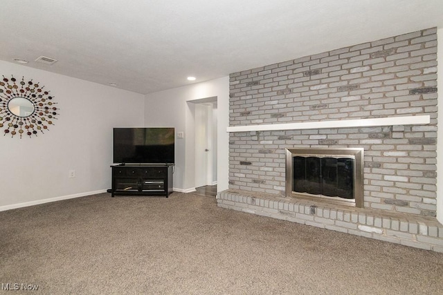 unfurnished living room with carpet floors and a fireplace