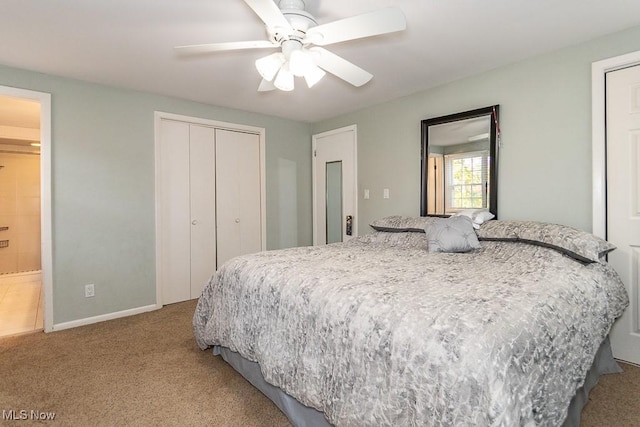 bedroom with light colored carpet, ceiling fan, and ensuite bathroom