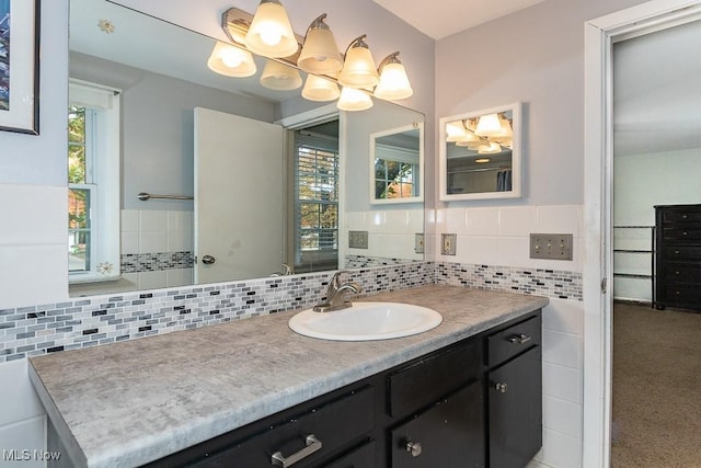 bathroom with vanity, a healthy amount of sunlight, and backsplash