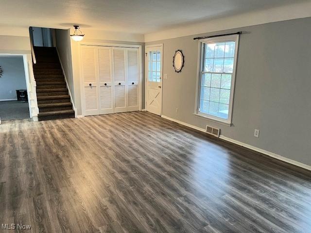 unfurnished living room with dark hardwood / wood-style flooring