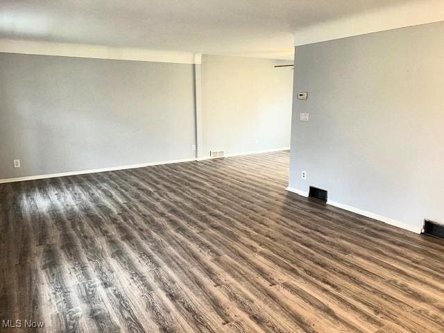 spare room featuring dark hardwood / wood-style flooring