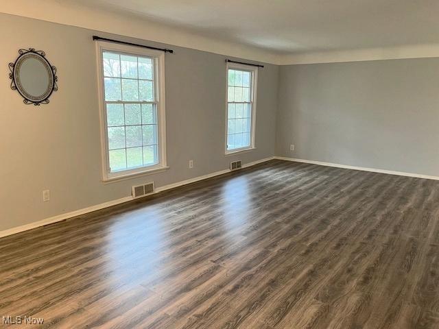 unfurnished room featuring dark hardwood / wood-style flooring