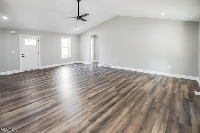 unfurnished living room with ceiling fan, vaulted ceiling, and dark hardwood / wood-style floors