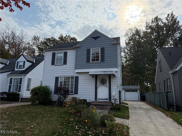 view of property featuring a front yard and a garage