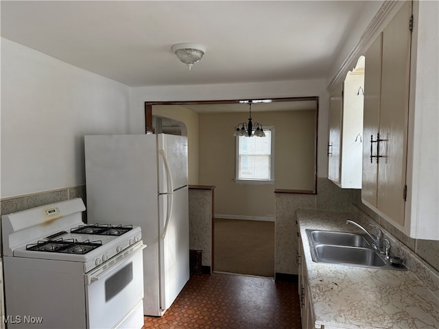 kitchen with sink, a notable chandelier, decorative light fixtures, and gas range gas stove