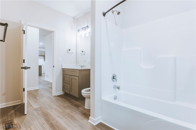 full bathroom with vanity, hardwood / wood-style floors, toilet, and shower / bathtub combination