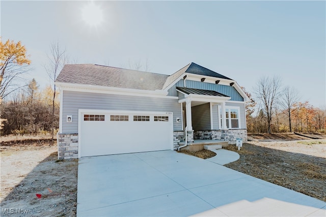 view of front facade with a porch and a garage