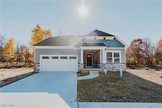 craftsman-style home featuring a porch and a garage