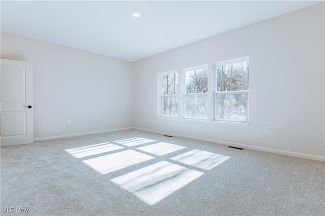 empty room featuring light carpet