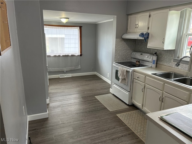 kitchen featuring dark hardwood / wood-style flooring, white range with electric stovetop, white cabinetry, and range hood