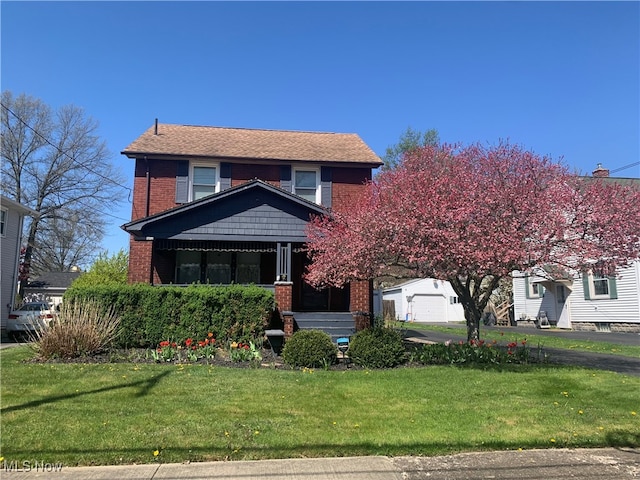 view of front of property featuring a garage and a front yard