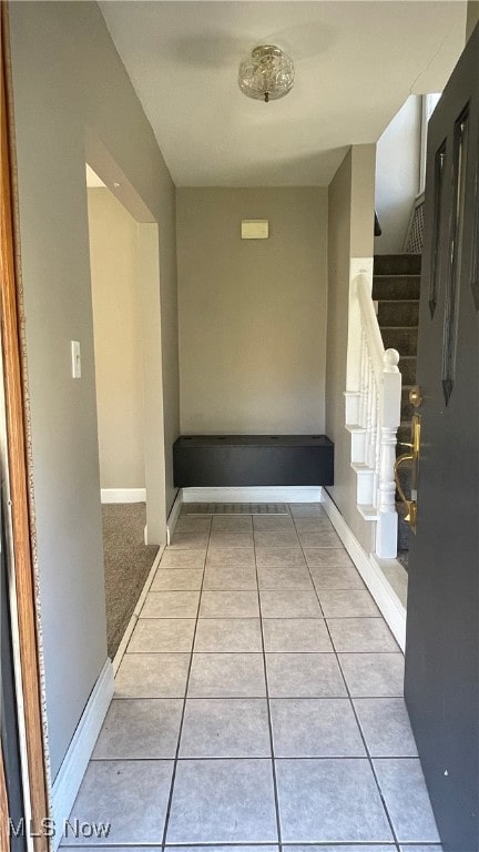 hall featuring light tile patterned floors