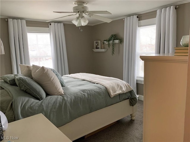 bedroom featuring ceiling fan, crown molding, carpet, and multiple windows