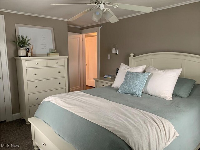 bedroom with carpet, ceiling fan, and ornamental molding