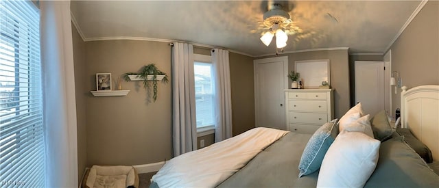 bedroom with ornamental molding, multiple windows, and ceiling fan