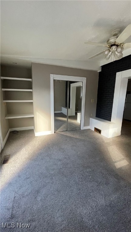 unfurnished living room with carpet and ceiling fan