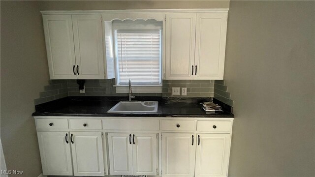 kitchen with sink, decorative backsplash, and white cabinets