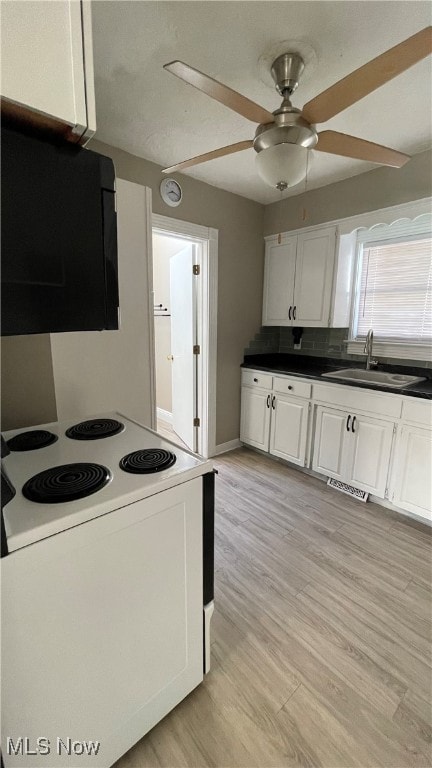 kitchen with white cabinetry, sink, light wood-type flooring, and ceiling fan