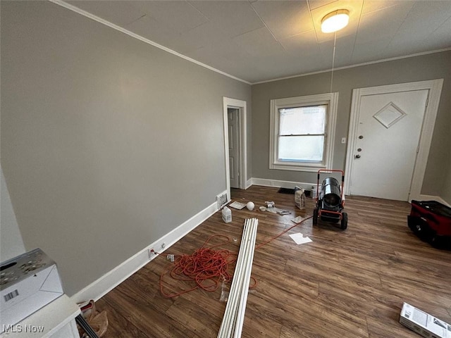 entryway featuring crown molding and hardwood / wood-style floors