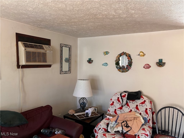 bedroom with a wall mounted AC and a textured ceiling