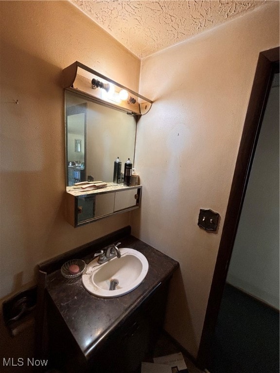 bathroom featuring vanity and a textured ceiling