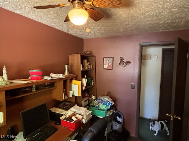 office area with a textured ceiling and ceiling fan