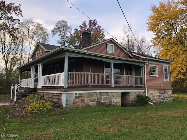 farmhouse with a porch and a front yard