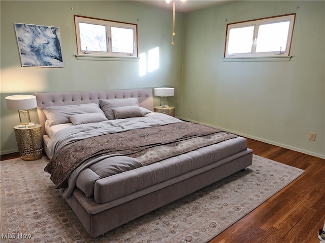 bedroom featuring multiple windows and hardwood / wood-style floors